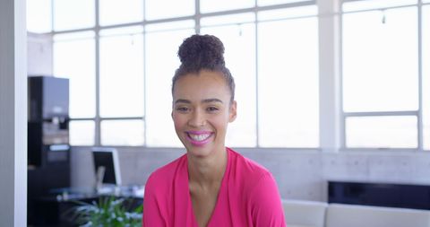 Smiling Woman Standing in Bright Office