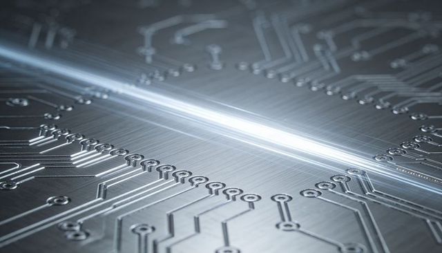 Futuristic metal circuit board reflecting light with engraved traces and circular pads