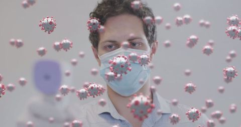 Healthcare worker with digital thermometer surrounded by floating virus particles