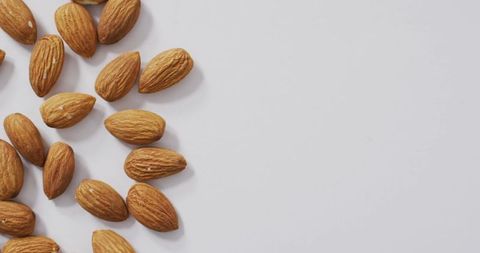 Raw Almonds Scattered on White Background for Healthy Eating - Download Free Stock Images Pikwizard.com