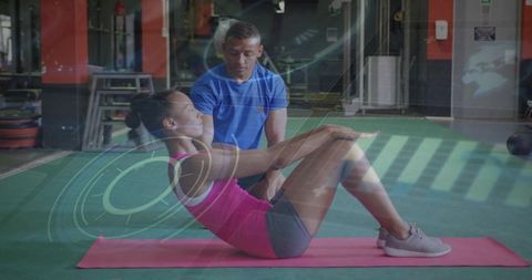 Female Client Performing Abdominal Crunches Under Digital Fitness Guidance