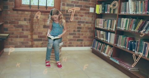 Girl reading tall book stack in cozy library
