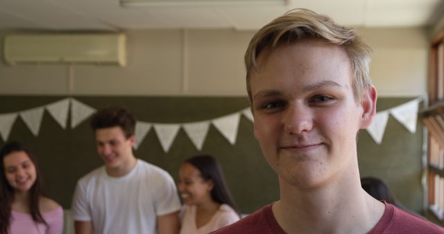 Teenager Smiling in Classroom with Friends in Background - Download Free Stock Images Pikwizard.com