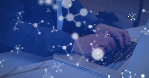 Innovative Technology: Man Typing on Laptop with Molecule Overlay