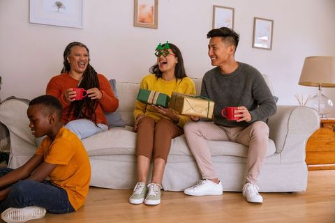 Diverse Family Joyfully Exchanging Gifts in Cozy Living Room