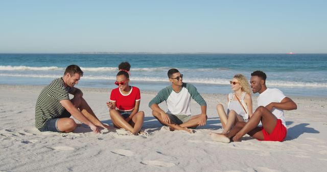 Diverse Group of Friends Sitting on Beach and Socializing - Download Free Stock Images Pikwizard.com