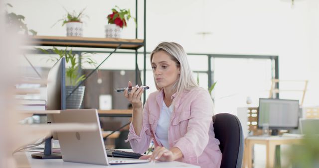 Focused Businesswoman Speaking into Phone in Modern Office - Download Free Stock Images Pikwizard.com