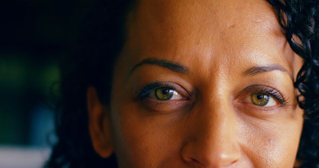 Close-Up of Serene Middle-Aged Woman with Dark Curly Hair and Green Eyes - Download Free Stock Images Pikwizard.com