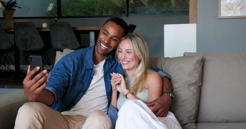 Smiling Couple Sharing Engagement News on Video Chat
