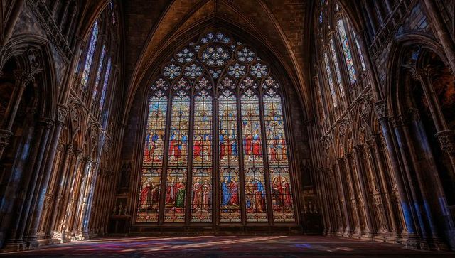 Gothic cathedral stained glass casting vibrant light patterns