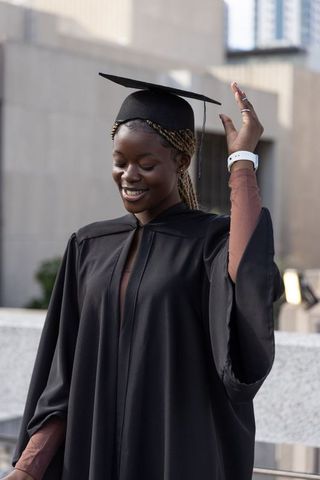 African american woman graduating on urban rooftop celebrating achievement and joy