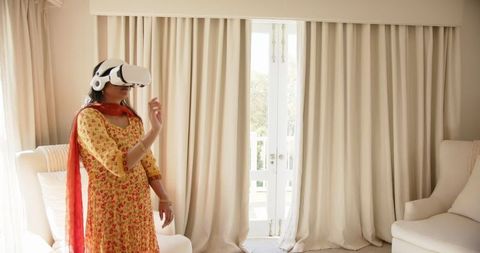 Indian Woman in Traditional Dress Exploring VR Technology at Home