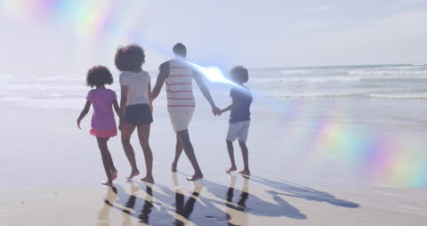 Family Enjoying Walk on Sunny Beach with Light Effects