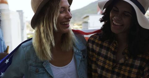 Friends Celebrating with American Flag on Rooftop