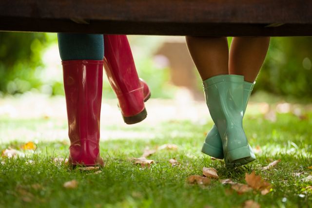 Mother and Daughter Wearing Colorful Rain Boots in Garden - Download Free Stock Photos Pikwizard.com