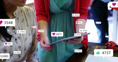 Women collaborating over tablet with social media likes and engagement overlays