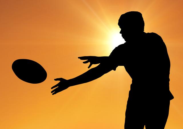 Digital composition of a man catching rugby ball against sky at dusk