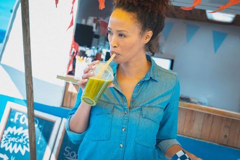 Woman Enjoys Fresh Green Smoothie at Food Truck