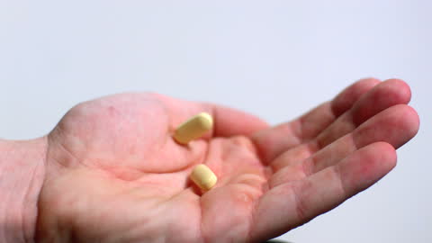 Open Hand Receiving Two Tablets Against Soft Reflection
