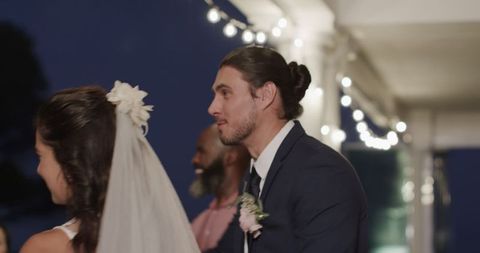 Bride and groom smiling at elegant evening wedding reception