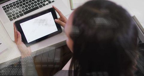 Woman Using Digital Tablet at Modern Office Desk