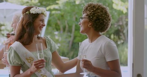 Women Celebrating Outdoors at Friendship Gathering with Champagne