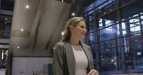 Confident businesswoman in modern office lobby