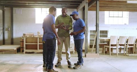 African American Carpenters Discuss Plans in Workshop