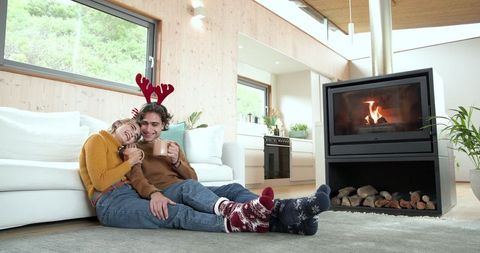 Festive Friends Enjoying Cozy Fireplace in Modern Living Room