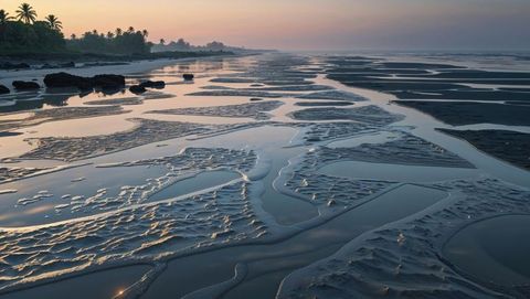 Tidal flats reflection at sunrise with tranquil bay of bengal seascape