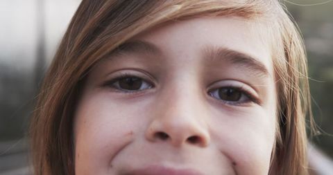 Close-Up of Smiling Child with Long Hair