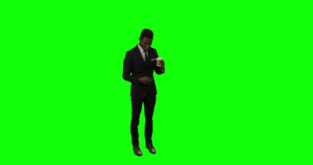 Businessman Checking Phone with Coffee on Green Background - Download Free Stock Images Pikwizard.com