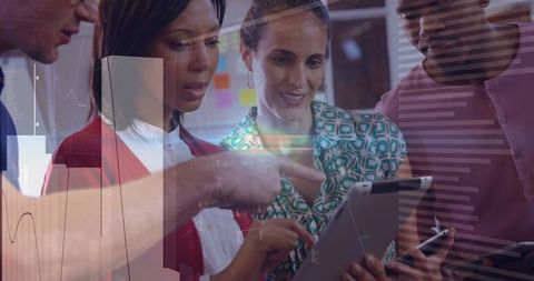 Multicultural Team Collaborating on Tablet With Data Charts and Smartphone for Business