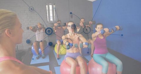 Instructor guiding group stability ball strength training with dumbbells and tech overlay