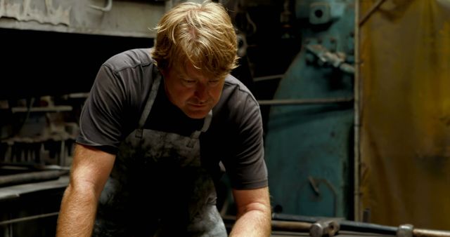 Blacksmith Concentrating on Craft in Traditional Workshop - Download Free Stock Images Pikwizard.com