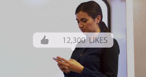 Businesswoman Engaged on Smartphone with Social Media Likes