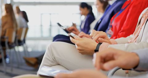 Professionals Engaged with Digital Devices at Business Seminar - Download Free Stock Images Pikwizard.com