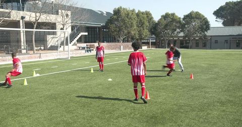 Youth Soccer Training on Sunny Field with Engaged Team