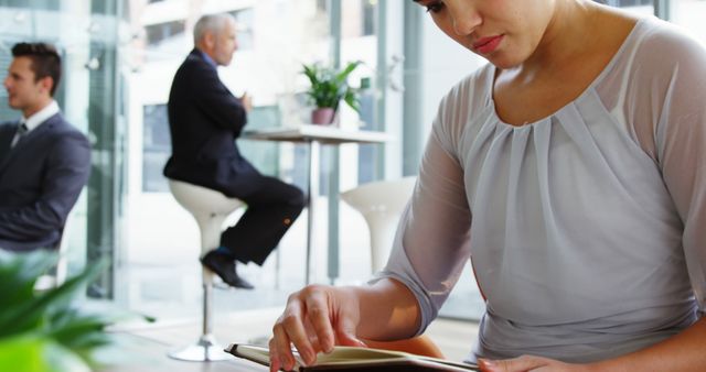 Businesswoman Reading Document in Modern Office - Download Free Stock Images Pikwizard.com