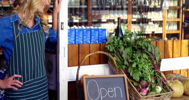 Smiling Female Shop Owner Welcoming Customers with Open Sign and Fresh Produce - Download Free Stock Images Pikwizard.com