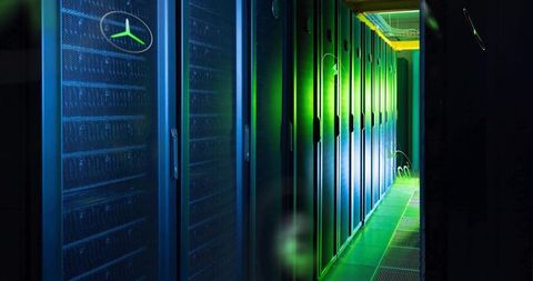 Glowing Server Rack Corridor Receding into Data Center with Vented Cabinets and Cable Trays