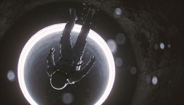 Inverted astronaut floating over illuminated circular portal in deep dark shaft