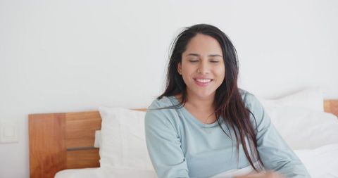 Relaxed Woman Enjoying Peaceful Morning in Cozy Bedroom