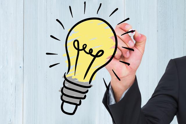 Hand drawing a light bulb on a wooden background symbolizes creativity and new ideas. Perfect for illustrating business innovation, brainstorming sessions, planning, and inspirational concepts. Suitable for use in business presentations, marketing materials, website graphics, and educational content.
