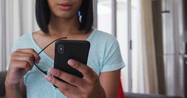 Close-up of Young Adult Looking at Smartphone Screen Indoors - Download Free Stock Images Pikwizard.com