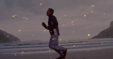 Man Jogging on Beach with Digital Technology Overlay