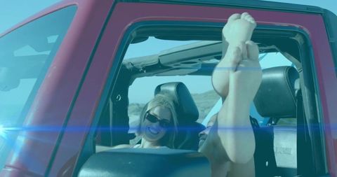 Women Enjoying Adventure Ride in Open-Top SUV in Desert Sun