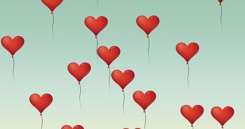 Floating Red Heart Balloons Against Pastel Green Backdrop
