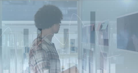 Business Professional Analyzing Photographs with Graphs Overlay