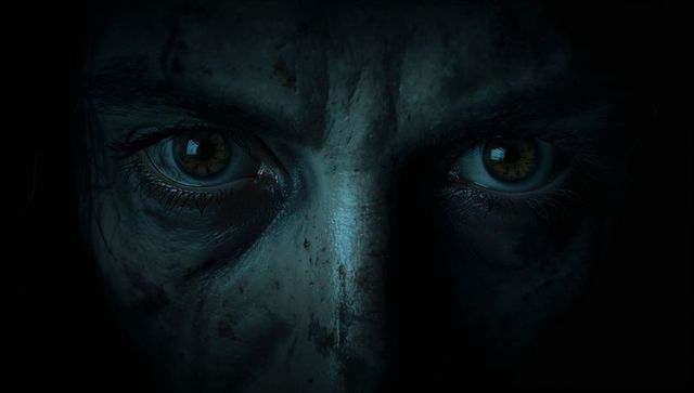 Moody close-up portraying intense emotion in deep shadow